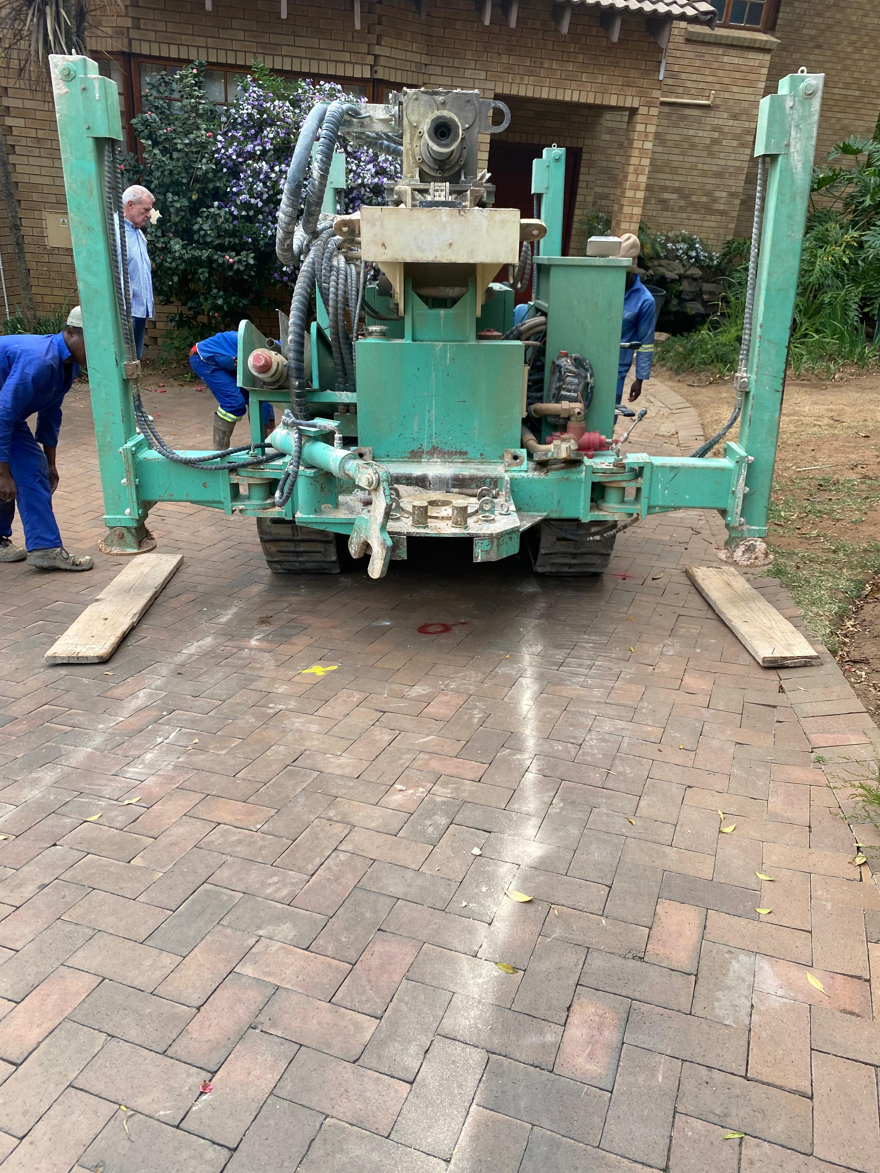 Borehole drilling prep on residential driveway site